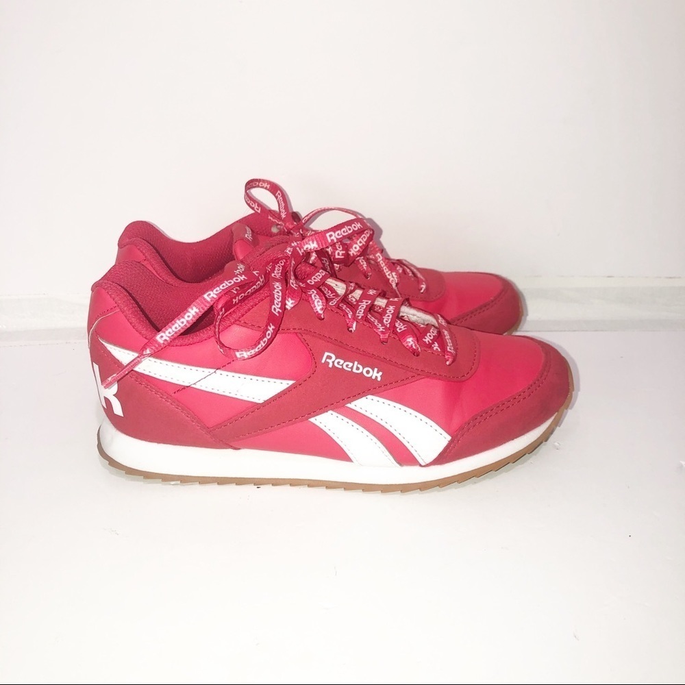 Reebok red classics with repeating logo strings.